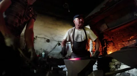 Smith Handles a Hot Workpiece in an Ancient Smithy in the Carpathians Stock Footage 59762098