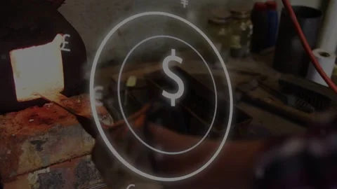Smith reaching into forge pulling hot rod, placing in vise for forming while Stock Footage 333859690