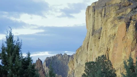 Smith Rock, Central Oregon, red rock rises dramatically with clouds Video stock 83180757