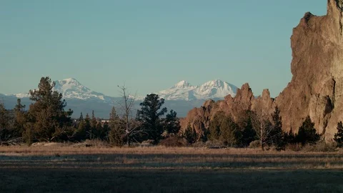 Smith Rock wall with Snow covered mountains behind Stock Footage 83230429