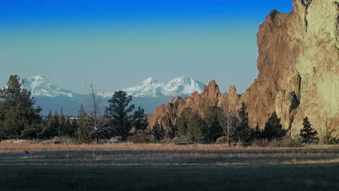 Smith Rock wall with Snow covered mountains behind Stock Footage 83230694