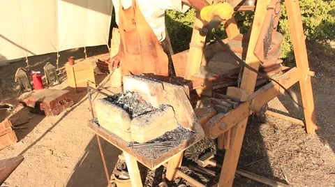 Smith is Using Bellows and Fire Iron Stock-Footage 65020706