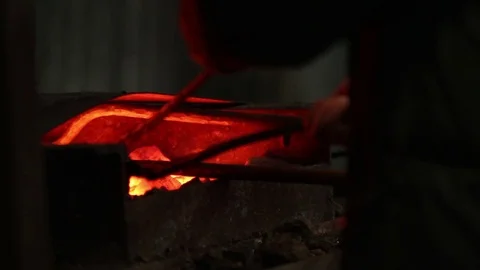 In smithy blacksmith takes iron out of fire Stock Footage 72219742