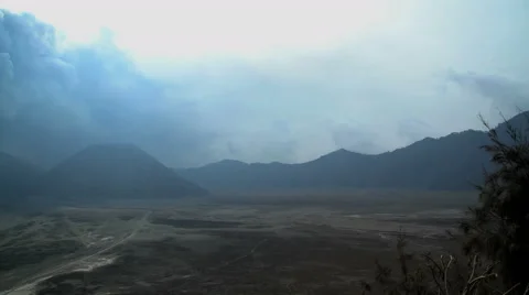 Smoke and ash from Mount Bromo volcano Delta river mud Java Indonesia Stock Footage 67394952