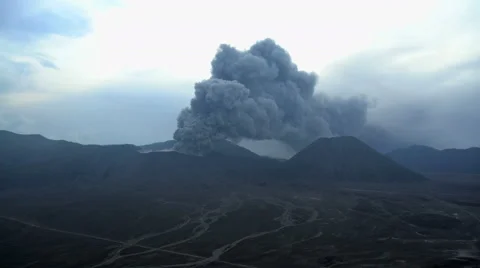 Smoke and ash from Mount Bromo volcano Delta river mud Java Indonesia Stock Footage 67395375