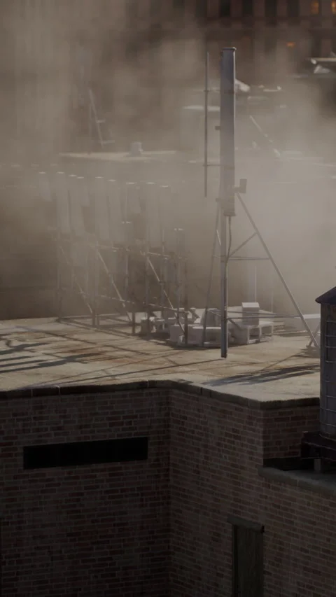Smoke and dust rise over a city rooftop during construction work in the daytime Stock Footage 340262045