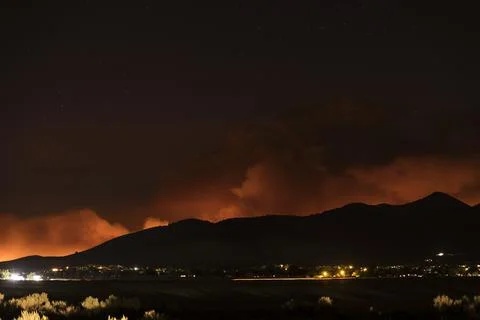 Smoke and fire clouds over the hill from a community Stock Photos