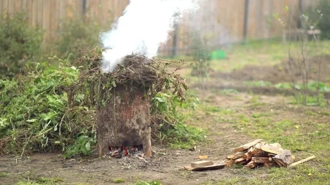 Smoke and fire from during Burning of garden waste Stock Footage 80300839