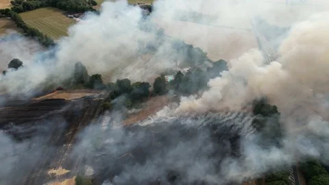 Smoke and flames Farm fields on fire in Essex UK summer 2022  heatwave drone Stock-Footage 201370835