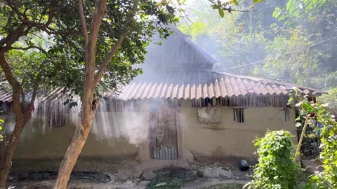 Smoke is billowing out from inside the mud house. Stock Footage 334795131