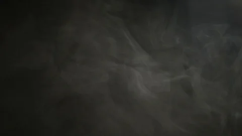 Smoke billowing over a black background Stock Footage 86440448