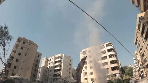 Smoke billows from a building that completely collapsed in the southern subu Stock Footage 289846514