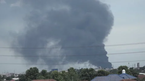 Smoke billows from the site of an explosion and fire. Stock Footage 156865166