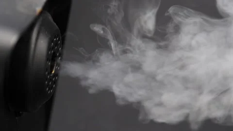 Smoke blasting out of smoke machine isolated on black Video stock 202731402
