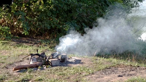 Smoke from a bonfire. Smoke constantly changes direction by wind. No person. Stock Footage 106784155
