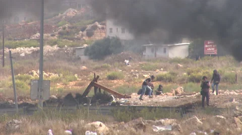 Smoke from burning tires, clashes between Palestinians and the Israeli army  Video stock 65076842