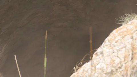 Smoke can be seen emerging from a cave Stock Footage 93001241