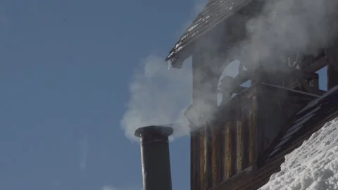 Smoke from chimney in close-up, with belfry behind Stock Footage 152494380