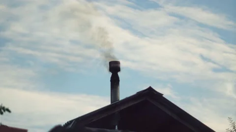 Smoke from the chimney of a house burning solid fuel in a wood-burning stove Stock Footage 206759773
