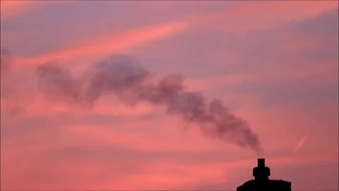 Smoke chimney Pollution against red sky Stock Footage