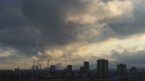 The smoke from the chimneys above the living area. Smoke rises into the sky over Stock Footage 144659953