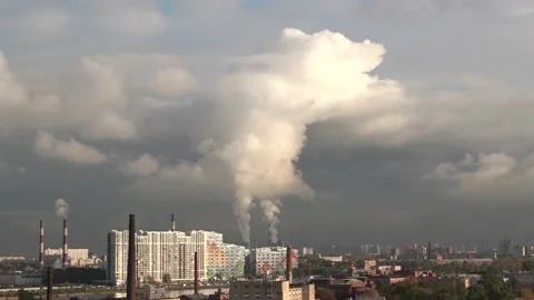 Smoke from chimneys forms clouds. A lot of pipes in industrial, residential area Stock Footage 143497475