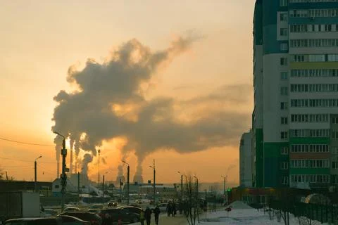 Smoke from CHP at sunset backdrop of small suburb of Chelyabinsk Stock Photos