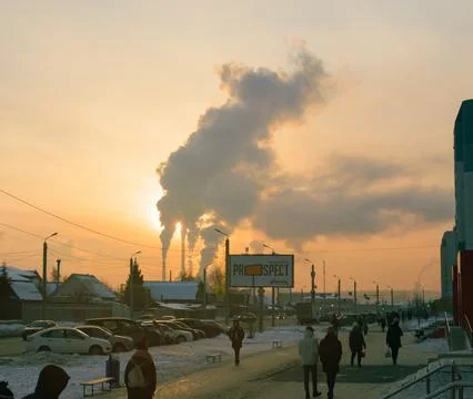 Smoke from CHP at sunset backdrop of small suburb of Chelyabinsk Stock Photos
