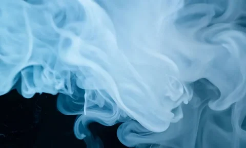 Smoke. Cloud of cold fog in blue light spot on black background Stock Footage 302286288
