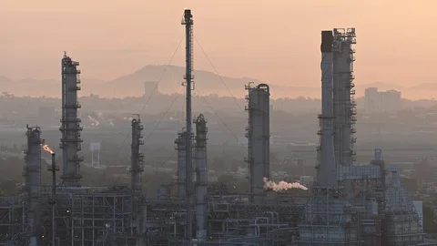 Smoke clouds come out of pipes on refinery factory at sunrise Stock Footage 125230855