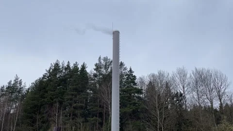 Smoke comes from a gray pipe background forest enterprise industry Stock Footage 310371369