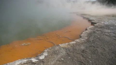 Smoke comes out of the multi-colored pools at Wai-O-Tapu, in New Zealand Stock Footage 215380446