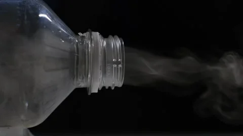 Smoke comes from a plastic bottle, close-up. Burning plastic waste concept Stock Footage 246878354