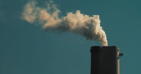 Smoke coming out of a coal power plant chimney against blue sky, close up Stock Footage 119371241