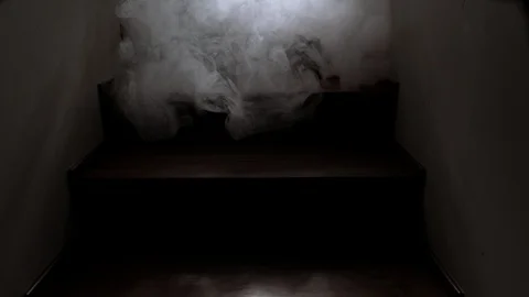Smoke creates shadow as it creeps down stairs horror or fire scene Stock Footage