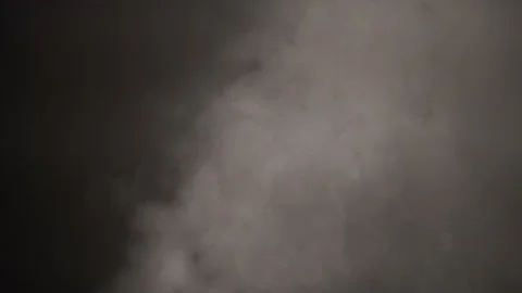 Smoke in a dark room with a sub-light. Defocus Stock Footage 144184314