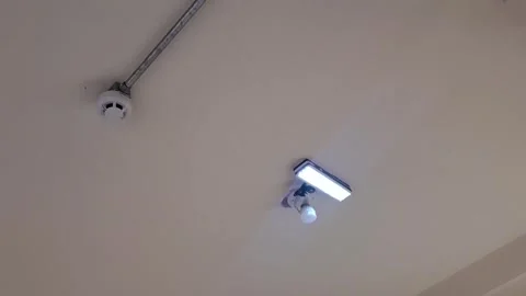 Smoke detector and bright led light mounted on ceiling video footage Stock Footage 339976787