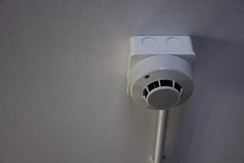Smoke detector on ceiling for preventing fire incident Stock Photos