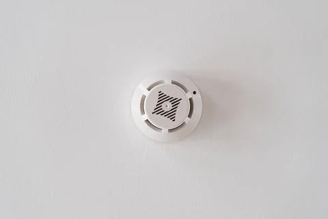 Smoke detector on the white ceiling. fire alarm. home protection Stock Photos