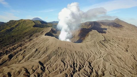 Smoke erupting from Mount Bromo, Java, Indonesia, Flying towards volcano Stock Footage 128389637