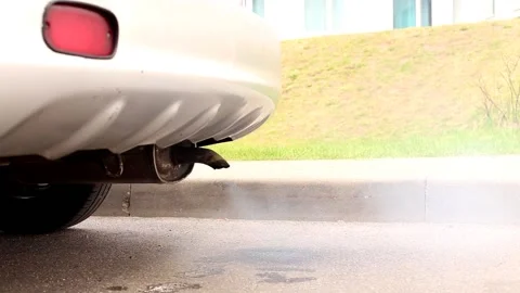 Smoke from the exhaust pipe of an old car. pollution ecology problem. Stock Footage 190020448