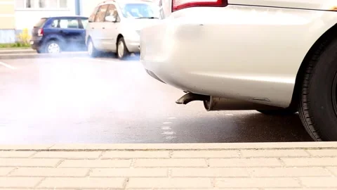 Smoke from the exhaust pipe of an old car. pollution ecology problem. Stock Footage 190020591