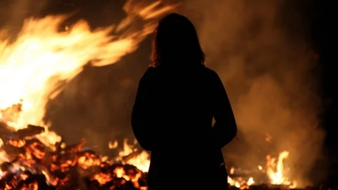 Smoke from the fire blows over person creating silhouette Stock Footage 122726542