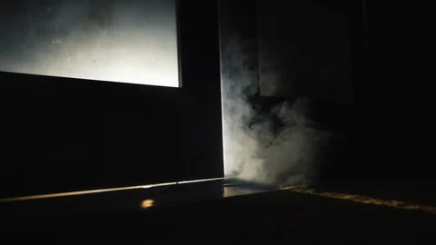 Smoke of fire coming from the cracks under the door in the room Stock Footage 124687939