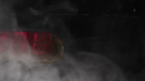 Smoke from fire rises around black digital clock blinking 12:00 a.m. slow motion Stock Footage 204062400