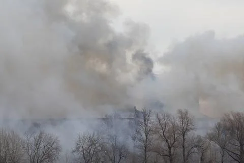 Smoke from a fire in a textile factory Stock Photos