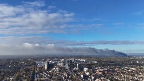 Smoke from fire visible over Hounslow, London Stock Footage 323680691