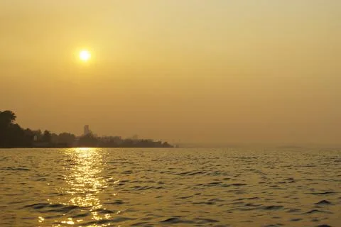 Smoke from forest fires enveloped lake coast of city in summer day Stock-Fotos