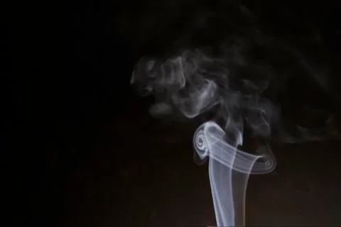 Smoke in the form of a scroll of paper. Stock Photos