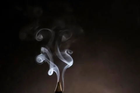 Smoke on a gray background in the form of a curl, wave, scroll Stock Photos